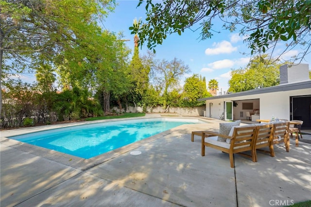 view of swimming pool featuring an outdoor living space and a patio area