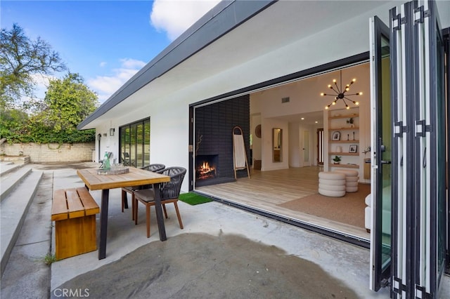 view of patio / terrace with exterior fireplace