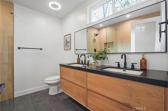 bathroom with vanity, toilet, tile patterned flooring, and a shower