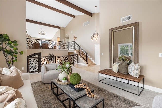 living room featuring beam ceiling, high vaulted ceiling, and a chandelier