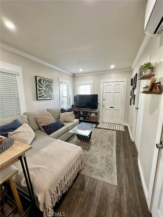 living room featuring ornamental molding, an AC wall unit, and dark wood-type flooring