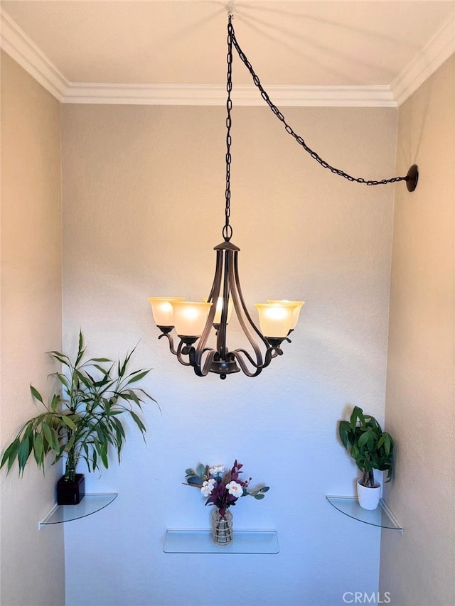 interior details with ornamental molding and a chandelier