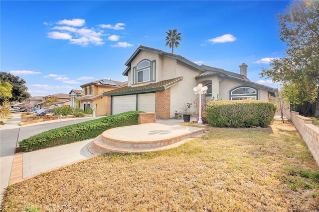 view of front of home with a garage and a front yard