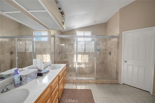 bathroom with vaulted ceiling, vanity, tile patterned floors, and a shower with shower door