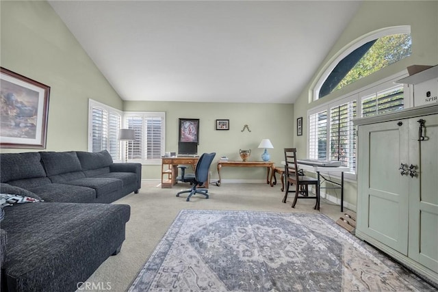 carpeted living room featuring high vaulted ceiling