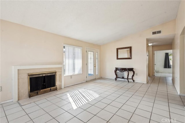 unfurnished living room featuring light tile patterned floors and vaulted ceiling