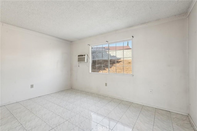 empty room with a wall unit AC, ornamental molding, and a textured ceiling