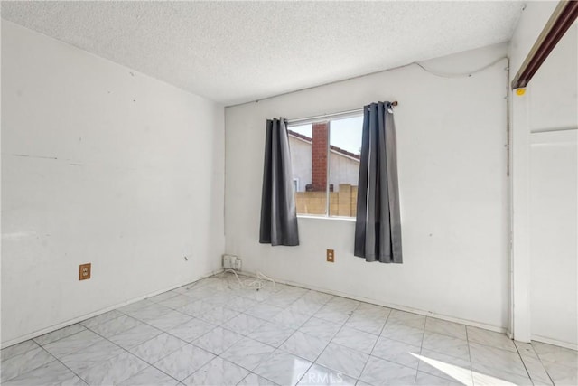 empty room with a textured ceiling