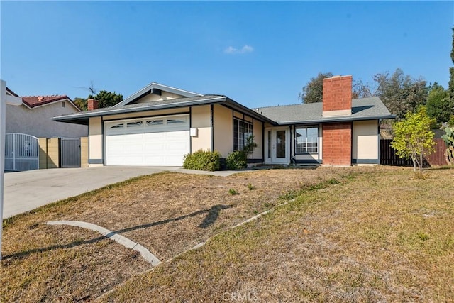 ranch-style home featuring a garage and a front lawn