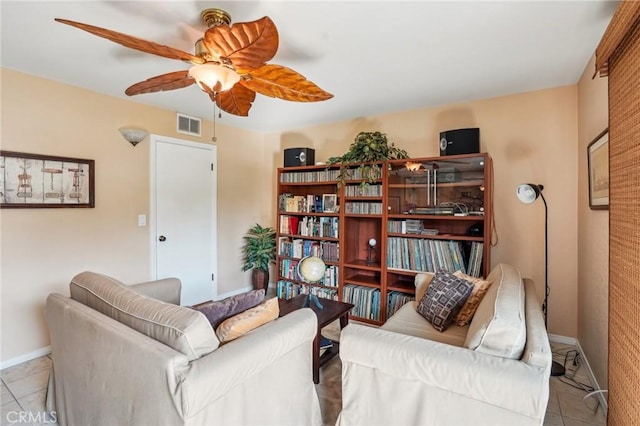 tiled living room with ceiling fan