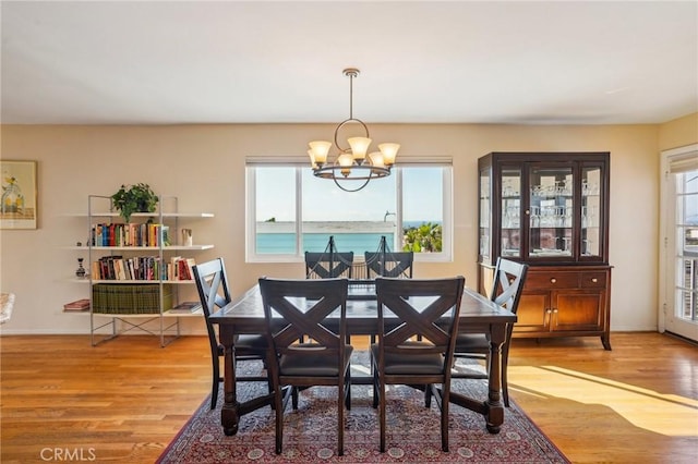 dining space with a chandelier, light wood-type flooring, and a wealth of natural light