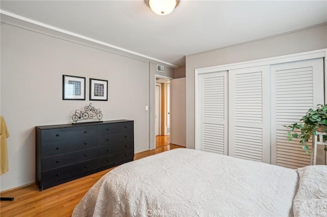 bedroom with hardwood / wood-style floors and a closet