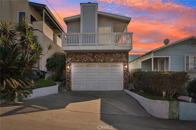 view of front of home featuring a garage and a balcony