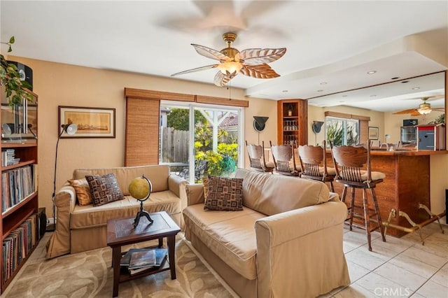 living room with light tile patterned floors and ceiling fan