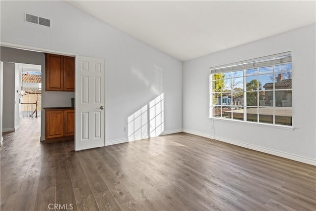 empty room with dark wood-type flooring