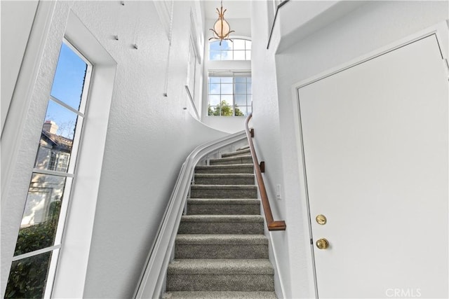 stairs featuring a towering ceiling