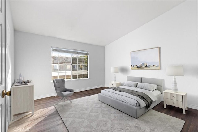 bedroom with lofted ceiling and wood-type flooring