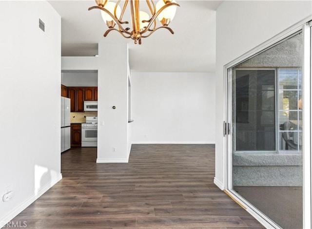 interior space featuring dark hardwood / wood-style flooring and a chandelier