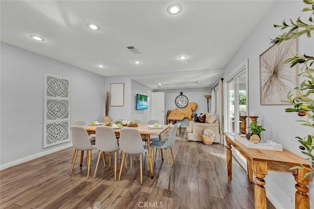 dining space with hardwood / wood-style flooring