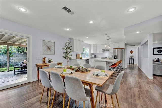 dining space with light hardwood / wood-style flooring