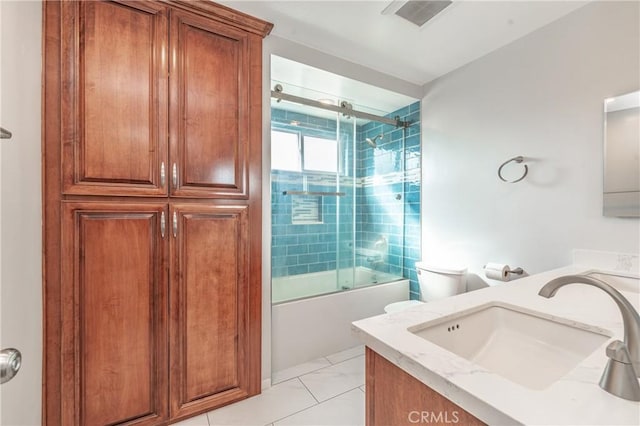 full bathroom with vanity, tile patterned floors, toilet, and combined bath / shower with glass door