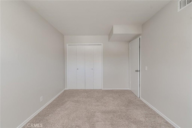 unfurnished bedroom with carpet floors and a closet