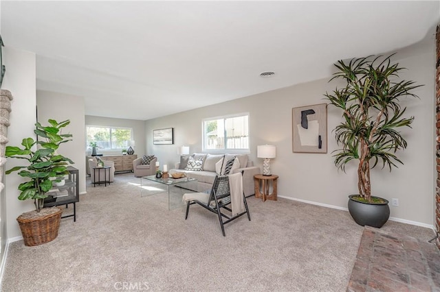 carpeted living room featuring plenty of natural light