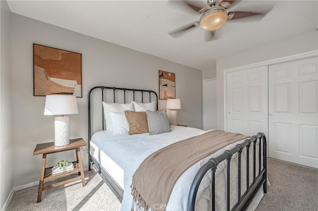 carpeted bedroom featuring ceiling fan and a closet