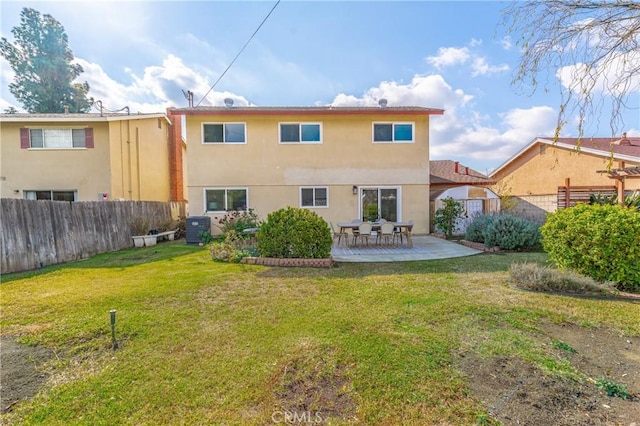 rear view of house featuring a patio, a yard, and central AC unit