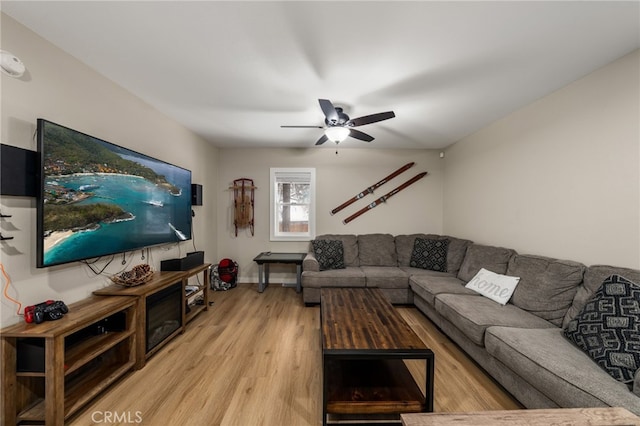 living room featuring light hardwood / wood-style floors and ceiling fan