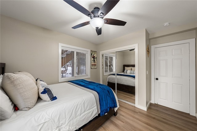 bedroom featuring ceiling fan, wood-type flooring, and a closet