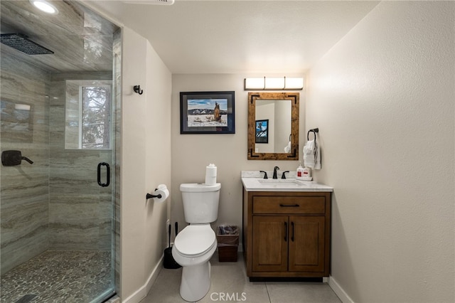 bathroom featuring vanity, tile patterned flooring, toilet, and walk in shower