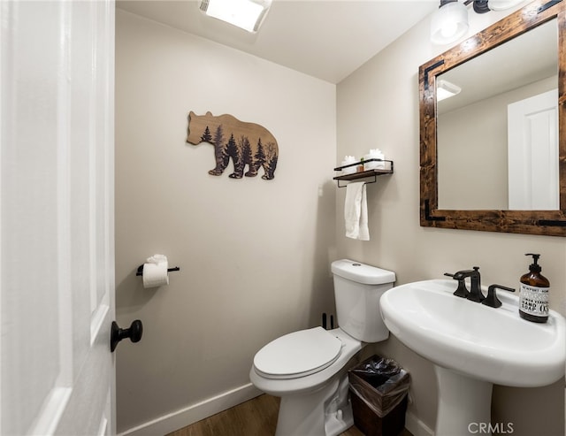 bathroom with sink, wood-type flooring, and toilet