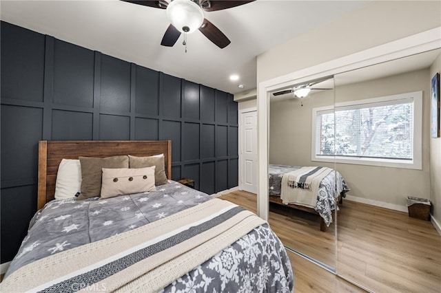 bedroom with a closet, ceiling fan, and light wood-type flooring