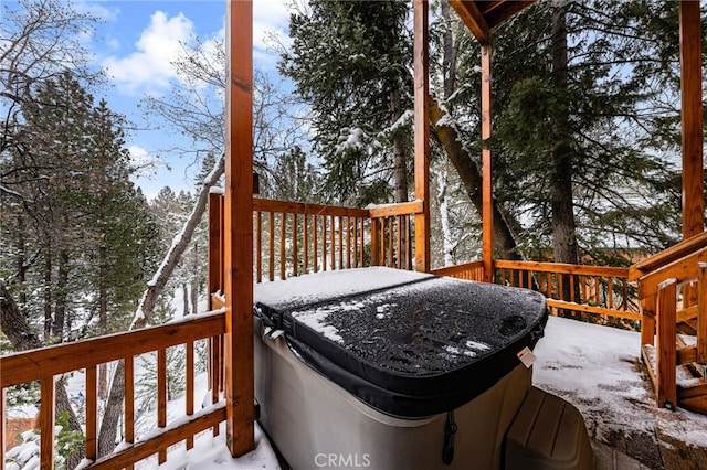 snow covered deck featuring a hot tub