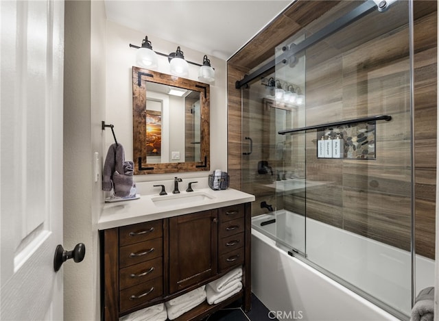 bathroom with bath / shower combo with glass door and vanity