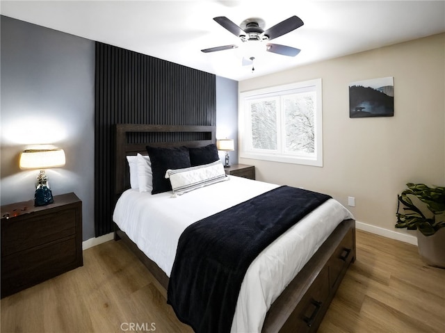 bedroom with light hardwood / wood-style floors and ceiling fan