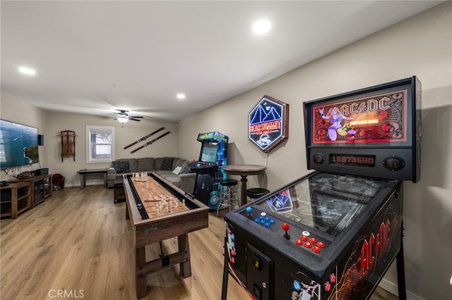 rec room with wood-type flooring and ceiling fan