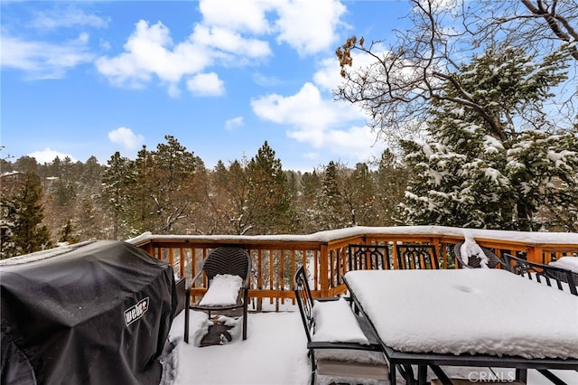 snow covered deck featuring grilling area