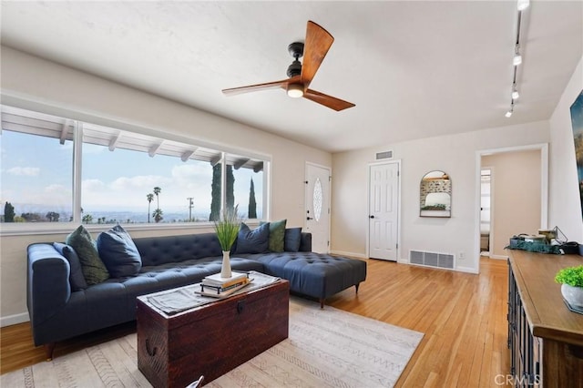 living room featuring track lighting, light hardwood / wood-style floors, and ceiling fan