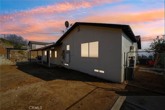 property exterior at dusk with a pergola