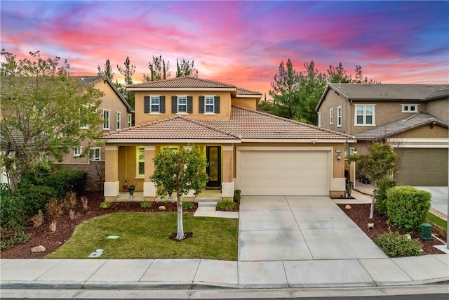 view of front of property featuring a garage, a front yard, driveway, and stucco siding