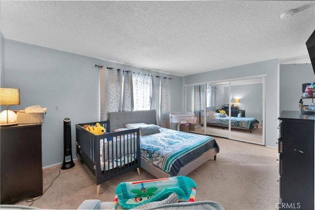 bedroom with carpet and a textured ceiling