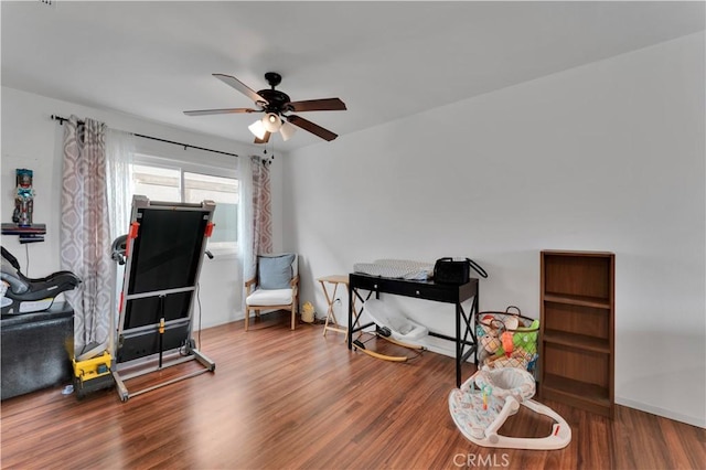interior space with wood finished floors and a ceiling fan