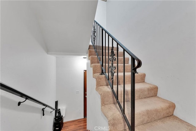 staircase featuring hardwood / wood-style flooring