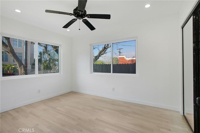 unfurnished bedroom featuring ceiling fan, light hardwood / wood-style floors, and a closet