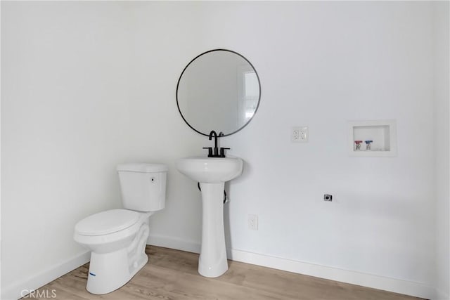 bathroom featuring hardwood / wood-style floors and toilet