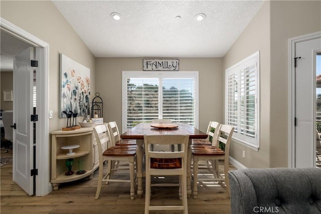 dining room featuring hardwood / wood-style floors and a textured ceiling