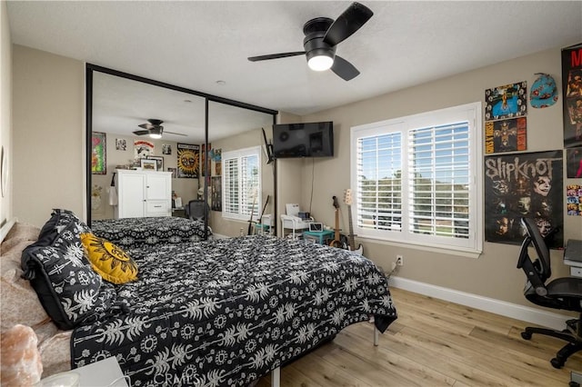 bedroom with light hardwood / wood-style flooring and ceiling fan