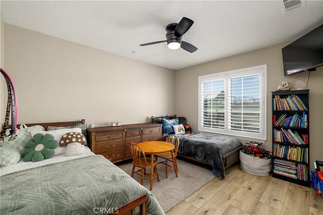 bedroom with light hardwood / wood-style floors and ceiling fan